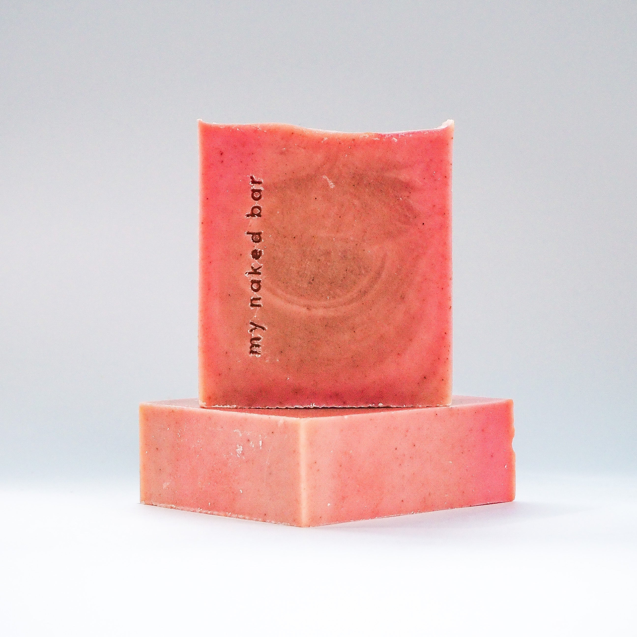 Front view of Rosehip Rhubarb Soap Bar stacked on another bar lying down