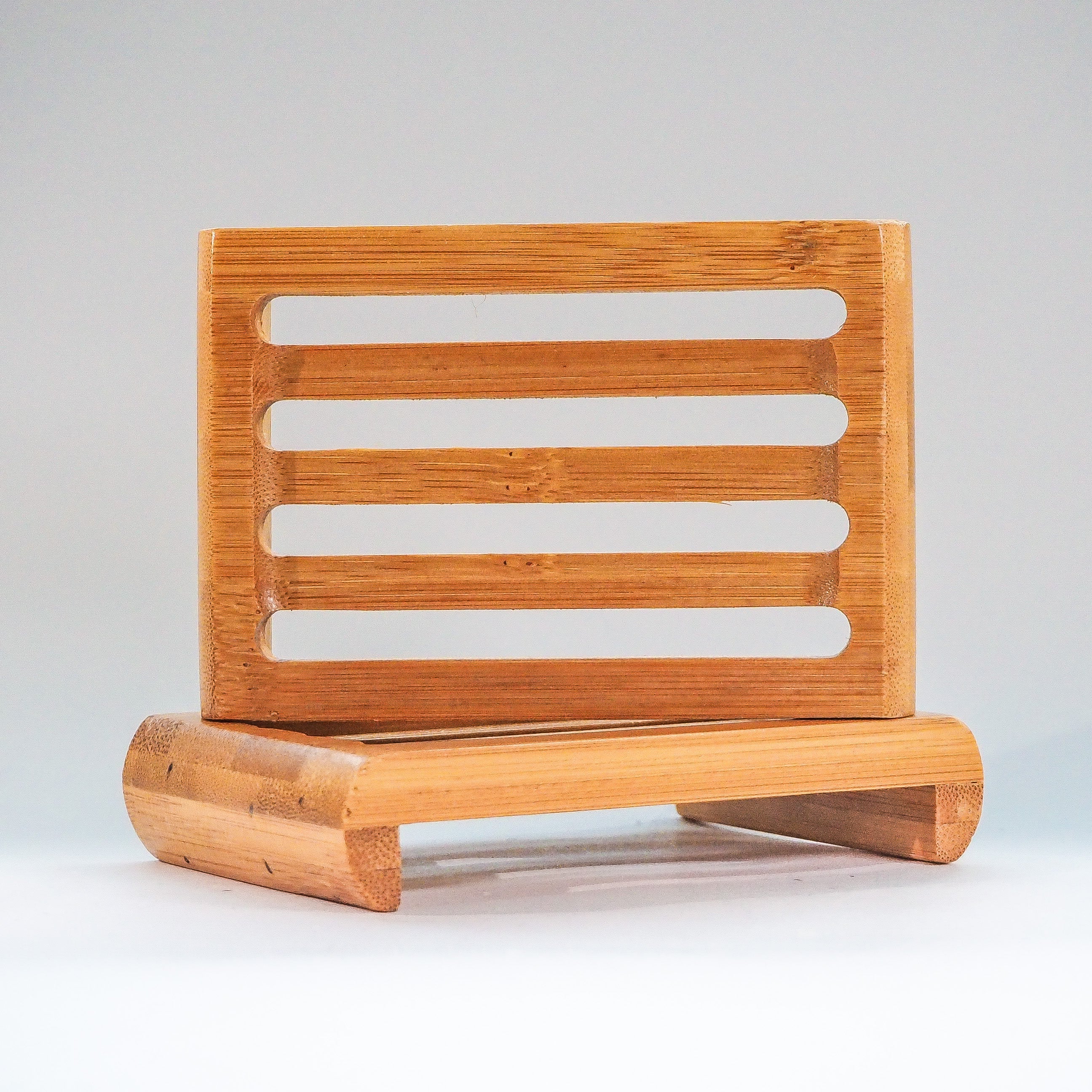Bamboo Soap Dish lying on side on top of another one flat on white table