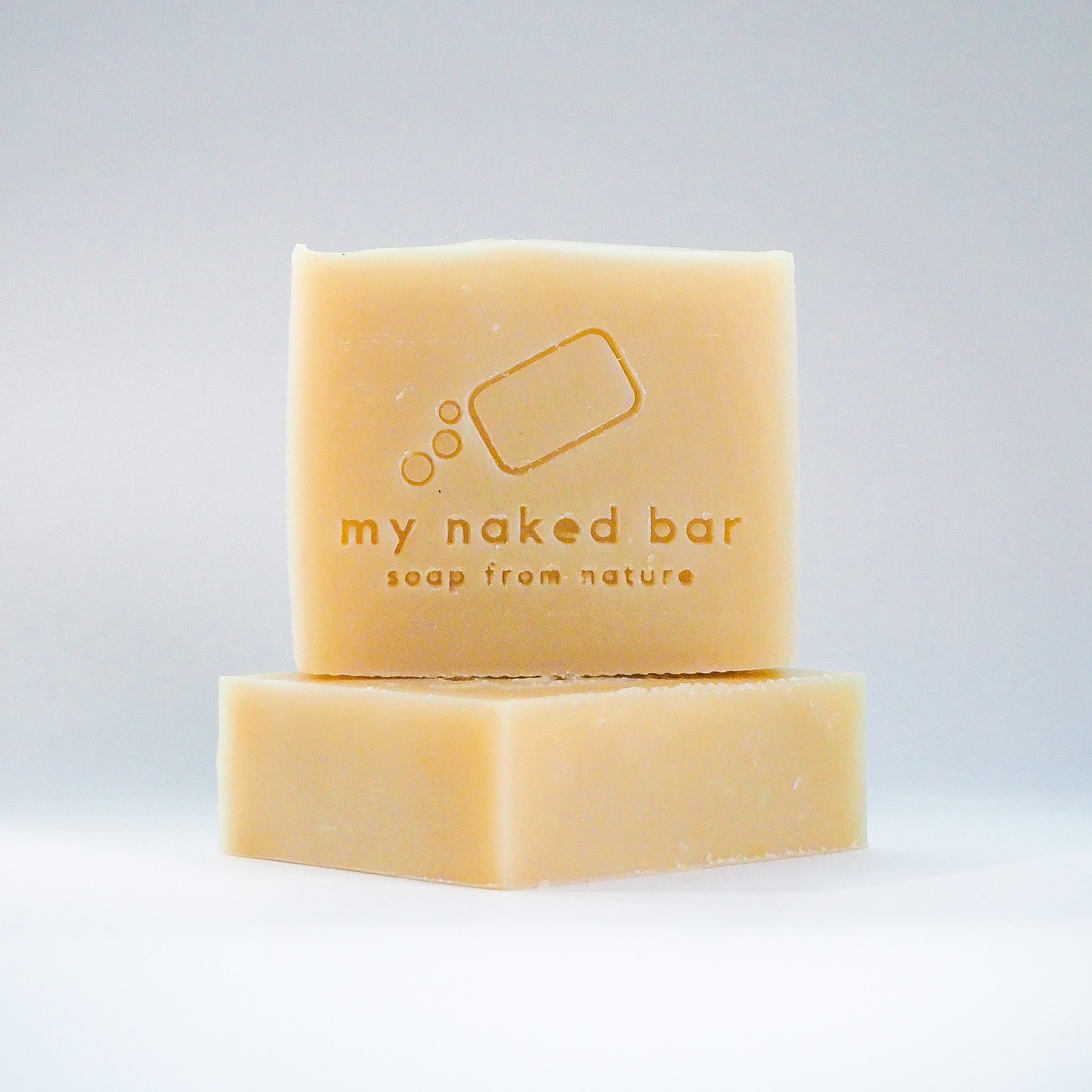 Front view of Cucumber Aloe soap bar stacked on another bar lying down