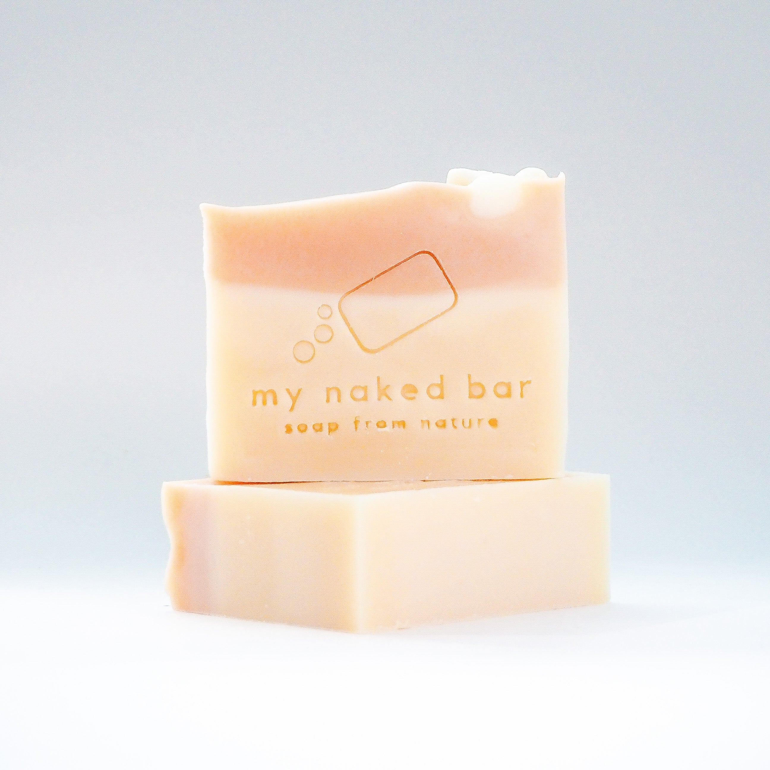 Front view of Marshmallow Bubblegum soap bar stacked on another bar lying down.