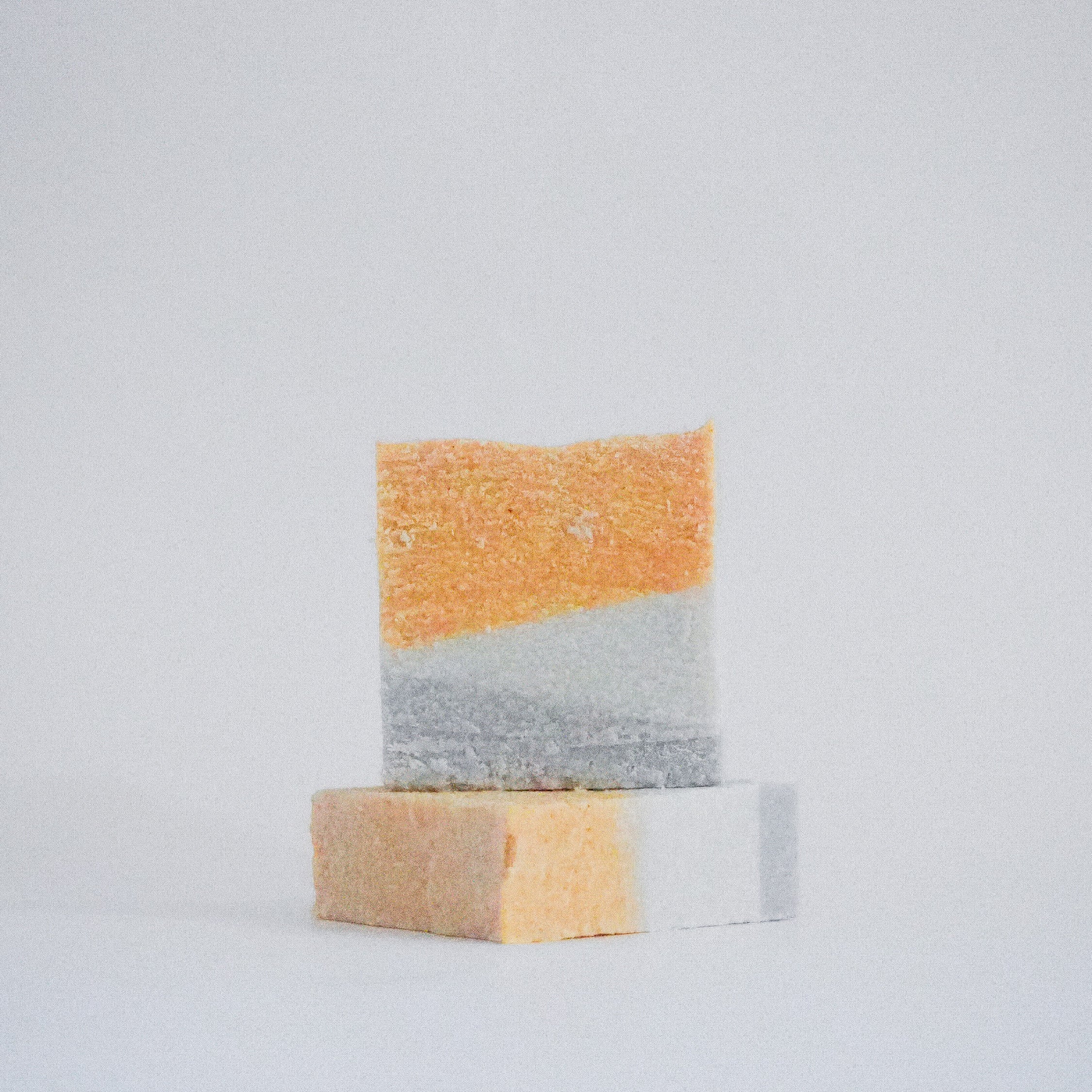 Front view of Celtic Salt Scrub Soap Bar for Psoriasis stacked on another bar lying down