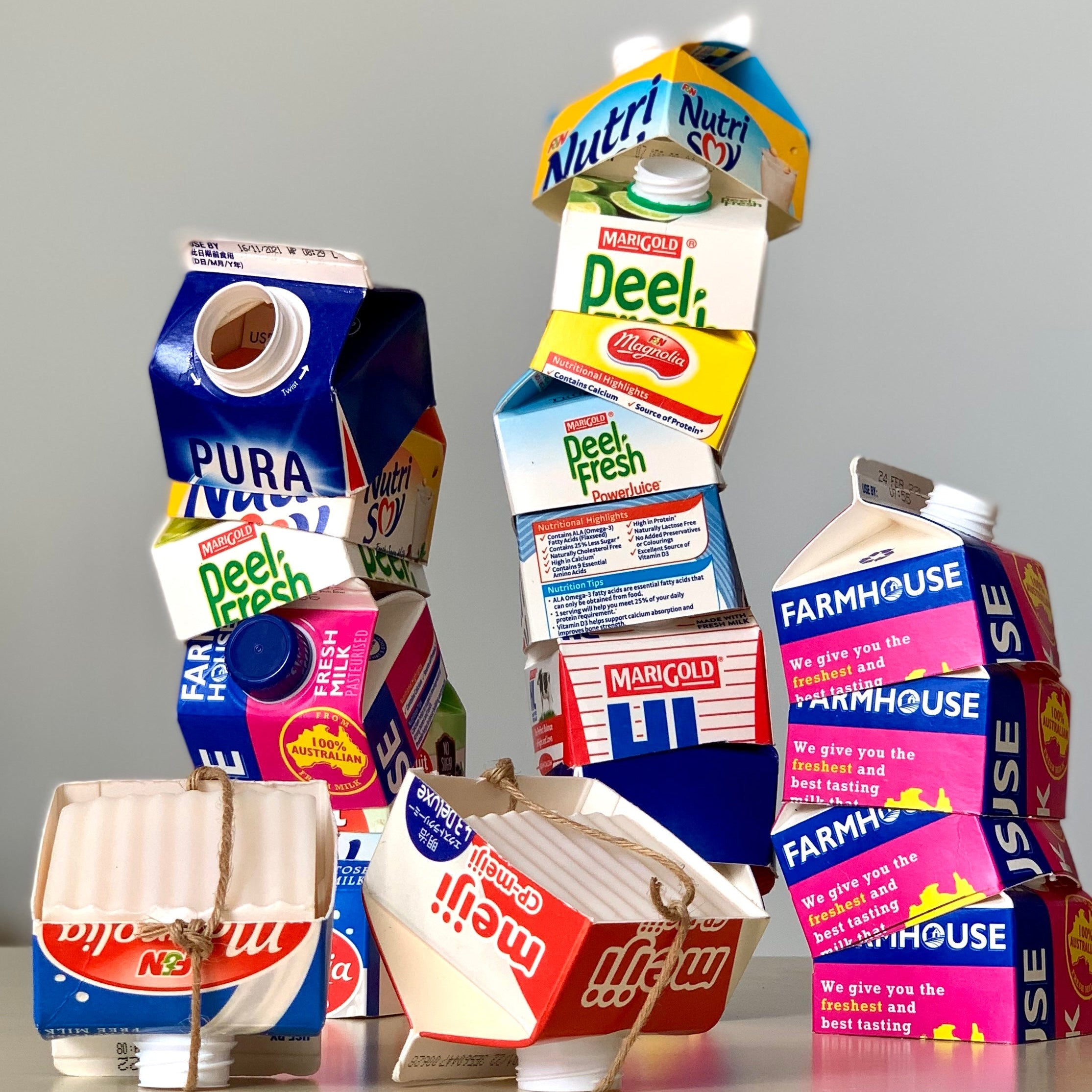 Stack of Milk Carton tops with 2 Kitchen Dish soap in upside down milk carton tops